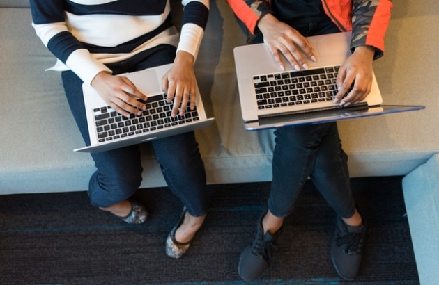 Two women using laptops.