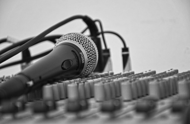 Microphone laying on a sound board.