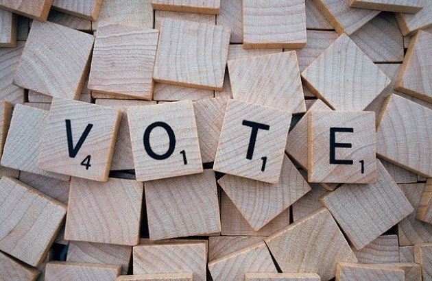 Scrabble tiles spell out "VOTE".